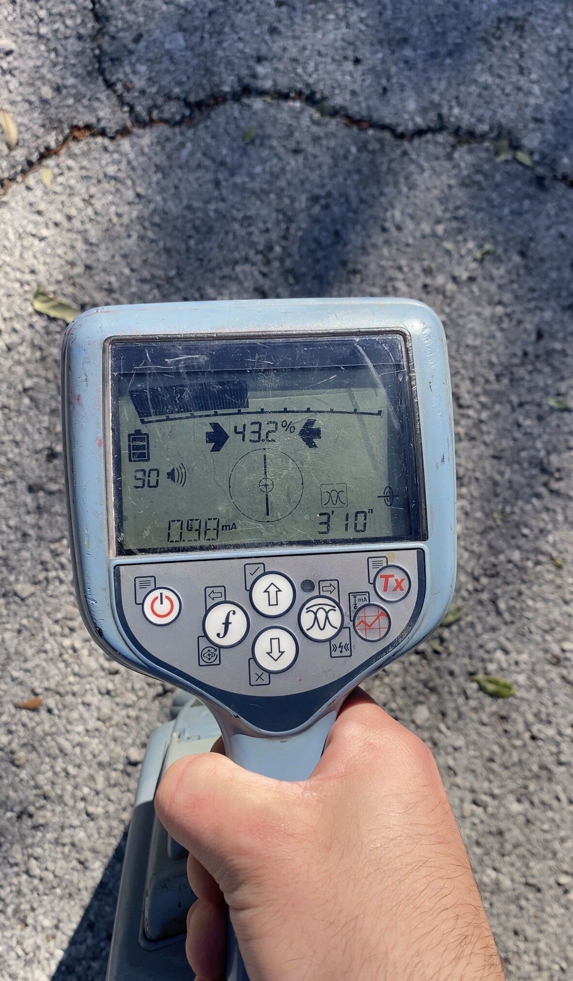 Electromagnetic utility locator showing a depth reading of three feet ten inches