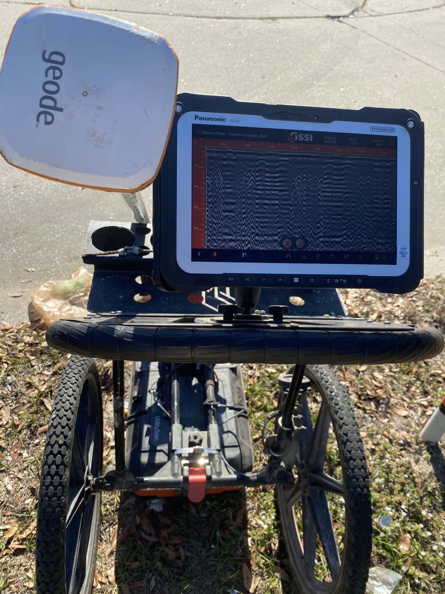 Ground penetrating radar cart with live subsurface scan data displayed on its field tablet